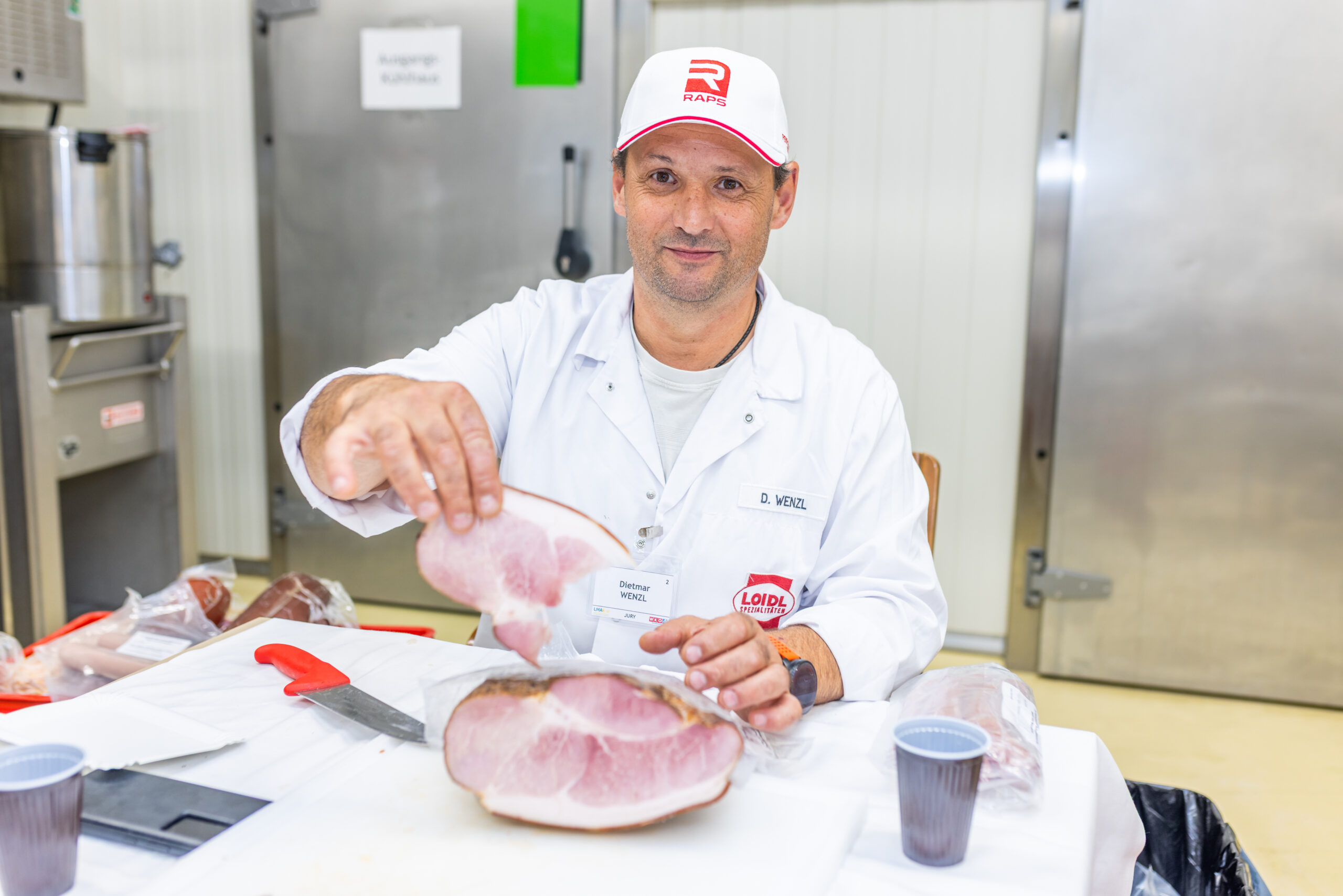 Dietmar Wenzl (Marcher Fleisch­ werke) beim fachgerechten Aufschneiden eines Schinkens. (Bild: LMAk/Der Handler)